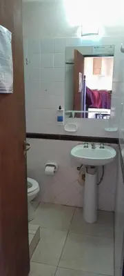 a bathroom with a sink and a toilet and a mirror at Posada in Merlo