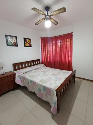 a bedroom with a bed and a ceiling fan at Departamento Centrico San Jose II in Villa Carlos Paz