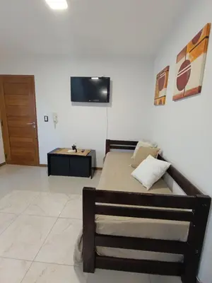 a bedroom with a bed and a tv on the wall at Departamento Centrico San Jose II in Villa Carlos Paz