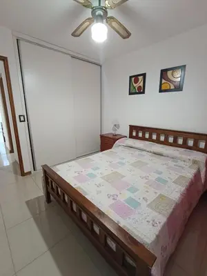 a bedroom with a bed and a ceiling fan at Departamento Centrico San Jose II in Villa Carlos Paz