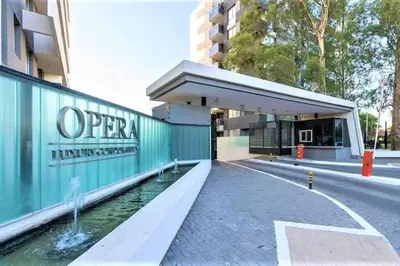 a building with a water fountain next to a building at Departamento Amoblado Premium en Opera Luxury in Cordoba