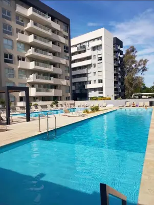 a large swimming pool in front of a building at Departamento Amoblado Premium en Opera Luxury in Cordoba