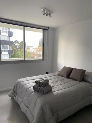 a bedroom with a large bed with towels on it at Departamento Amoblado Premium en Opera Luxury in Cordoba