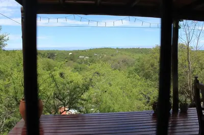 a view from a window of a deck with trees at La casita de la montaña in El Parador