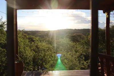 a view of a waterfall from a room with a window at La casita de la montaña in El Parador