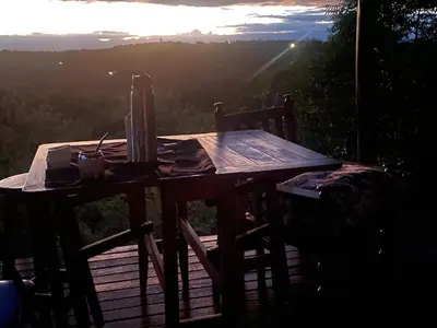 a wooden table sitting on top of a wooden deck at La casita de la montaña in El Parador