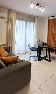 a living room with a couch and a table at Departamento alquiler temporal Barrio General Paz in Cordoba