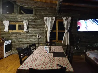 a dining room with a table and a television at Cabaña en los solares in Villa Ciudad Parque