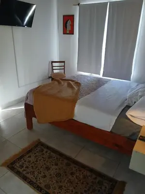 a bedroom with a large bed in a room at Respira Alegría in Carpintería