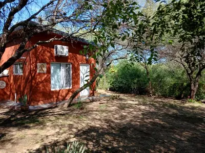 a small red house with trees in front of it at Respira Alegría in Carpintería