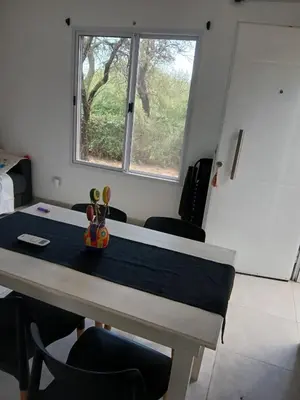 a room with a table with chairs and a window at Respira Alegría in Carpintería