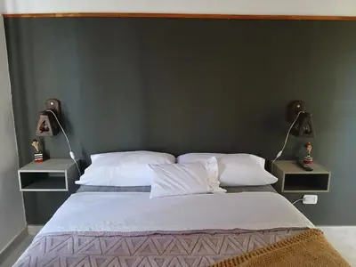 a bedroom with a large bed with two night stands at Respira Alegría in Carpintería