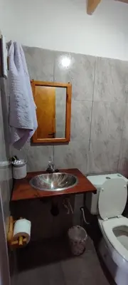 a bathroom with a sink and a toilet at Departamento en Villa Santa Cruz del Lago in Villa Santa Cruz del Lago