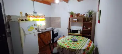 a kitchen with a refrigerator and a table in it at Departamento en Villa Santa Cruz del Lago in Villa Santa Cruz del Lago