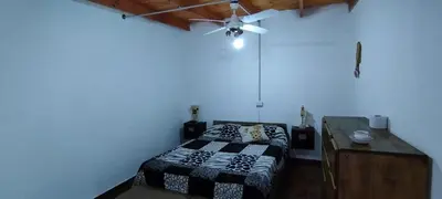 a bedroom with a bed and a ceiling fan at Departamento en Villa Santa Cruz del Lago in Villa Santa Cruz del Lago
