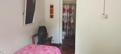 a room with a chair and a door with a rack of shoes at Departamento en Villa Santa Cruz del Lago in Villa Santa Cruz del Lago