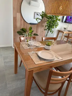 a wooden table with plates and glasses on it at A estrenar!! Nordic Chic in Cordoba