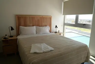 a bedroom with a large bed with a pillow on it at A estrenar!! Nordic Chic in Cordoba