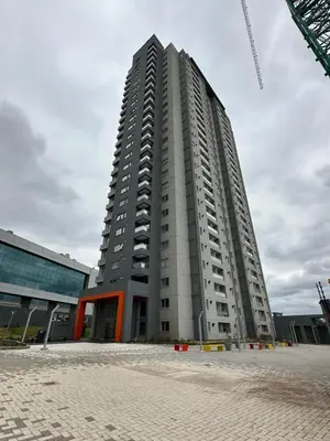 a tall grey building with a crane at A estrenar!! Nordic Chic in Cordoba