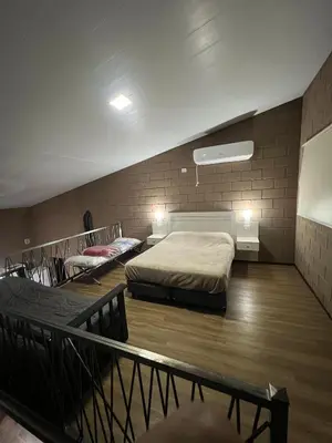 a bedroom with two beds in a room with brick walls at Chalet en Potrero de Garay in La Estancia
