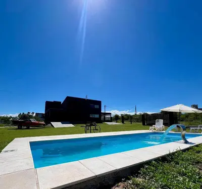 a swimming pool in the yard of a house at Chalet en Potrero de Garay in La Estancia