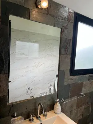 a large mirror above a sink in a bathroom at Chalet en Potrero de Garay in La Estancia
