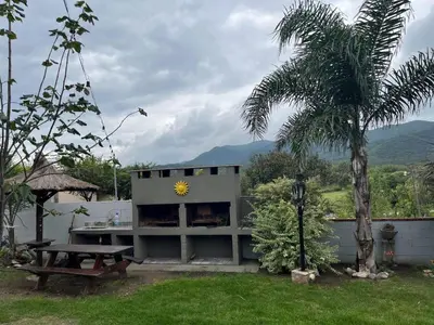 a building with a picnic table and a sunflower on it at COMPLEJO AyH in Malagueño