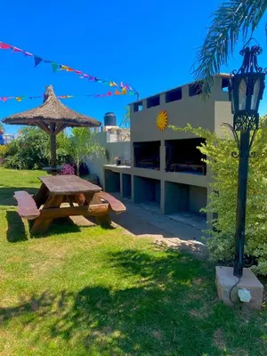 a picnic table and a street light next to a building at COMPLEJO AyH in Malagueño