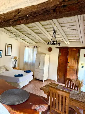 a bedroom with a bed and a table in a room at Casita de campo La Añurita in San Javier