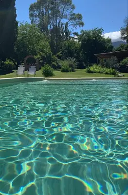 a swimming pool with blue water in a yard at Casita de campo La Añurita in San Javier