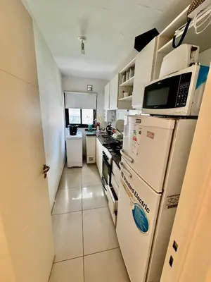a small kitchen with a stove and a microwave at Buena vista in Cordoba