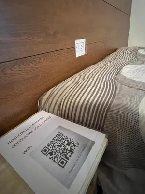 a book sitting on top of a bed at Hospedaje Malvinas in Alta Gracia