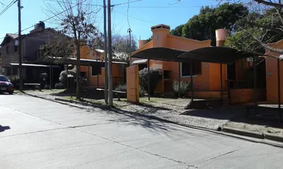 a building with an umbrella on the side of a street at Los Zarzos in Mina Clavero