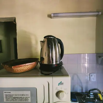 a tea kettle sitting on top of a microwave at Los Zarzos in Mina Clavero