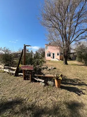 a sign on a fence in front of a house at Cabañas Megustayacanto in Villa Yacanto