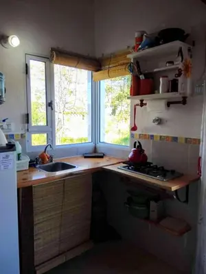 a small kitchen with a sink and a window at Cabañas Megustayacanto in Villa Yacanto