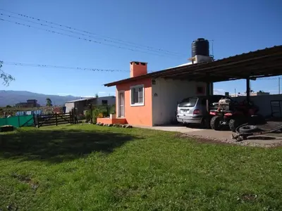 a house with a car parked in front of it at Cabañas Megustayacanto in Villa Yacanto