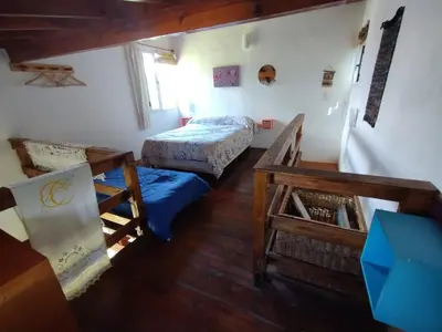 a small room with two beds and a table at Cabañas Megustayacanto in Villa Yacanto