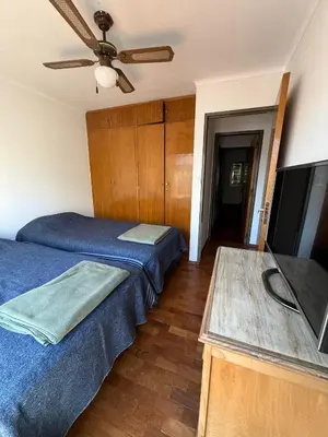 a bedroom with two beds and a flat screen tv at ituzaingo house in Cordoba