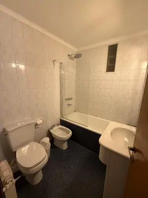 a bathroom with a toilet and a tub and a sink at ituzaingo house in Cordoba