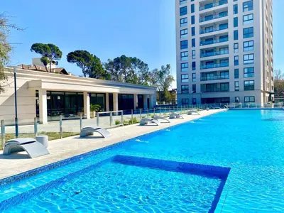 a large swimming pool in front of a building at Ópera Park Premium Stay in Cordoba