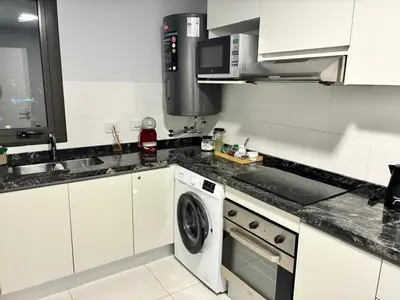 a white kitchen with a washing machine in it at Ópera Park Premium Stay in Cordoba