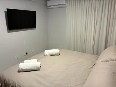 a bedroom with a bed with two towels on it at Ópera Park Premium Stay in Cordoba