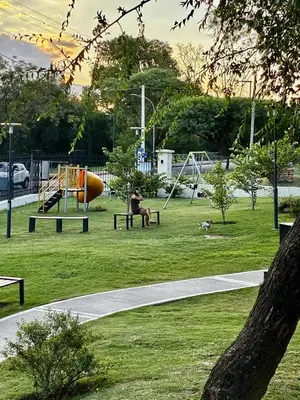 a person sitting on a bench in a park at Ópera Park Premium Stay in Cordoba