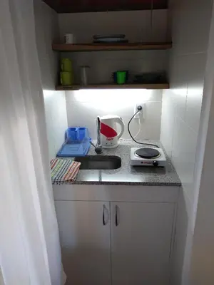 a small kitchen with a sink and a counter at Departamento Loma Hermosa in Santa Rosa de Calamuchita