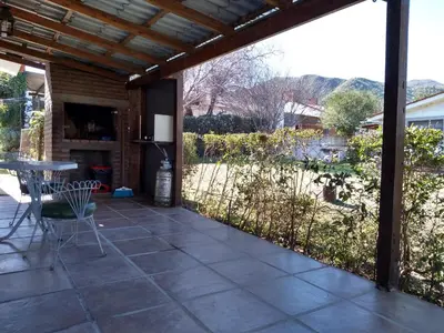 a patio with a table and chairs and a view at Departamento Loma Hermosa in Santa Rosa de Calamuchita