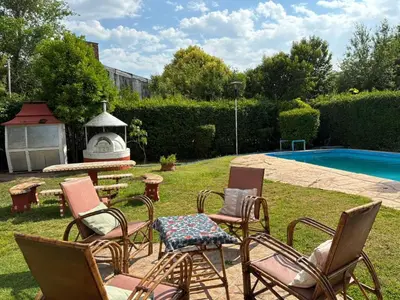 a group of chairs and a table next to a pool at Casas y Chalets Privados Valle del Reposo in Bialet Massé