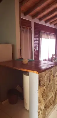 a kitchen with a wooden counter top in a room at Cabañas Valle del Chutunzo in San Francisco del Monte de Oro