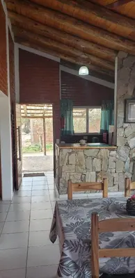 a room with a stone wall and a bed in it at Cabañas Valle del Chutunzo in San Francisco del Monte de Oro
