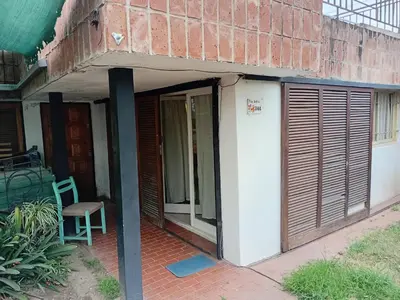 a brick building with a door and a chair on a patio at Monoambiente Alto Verde in Cordoba